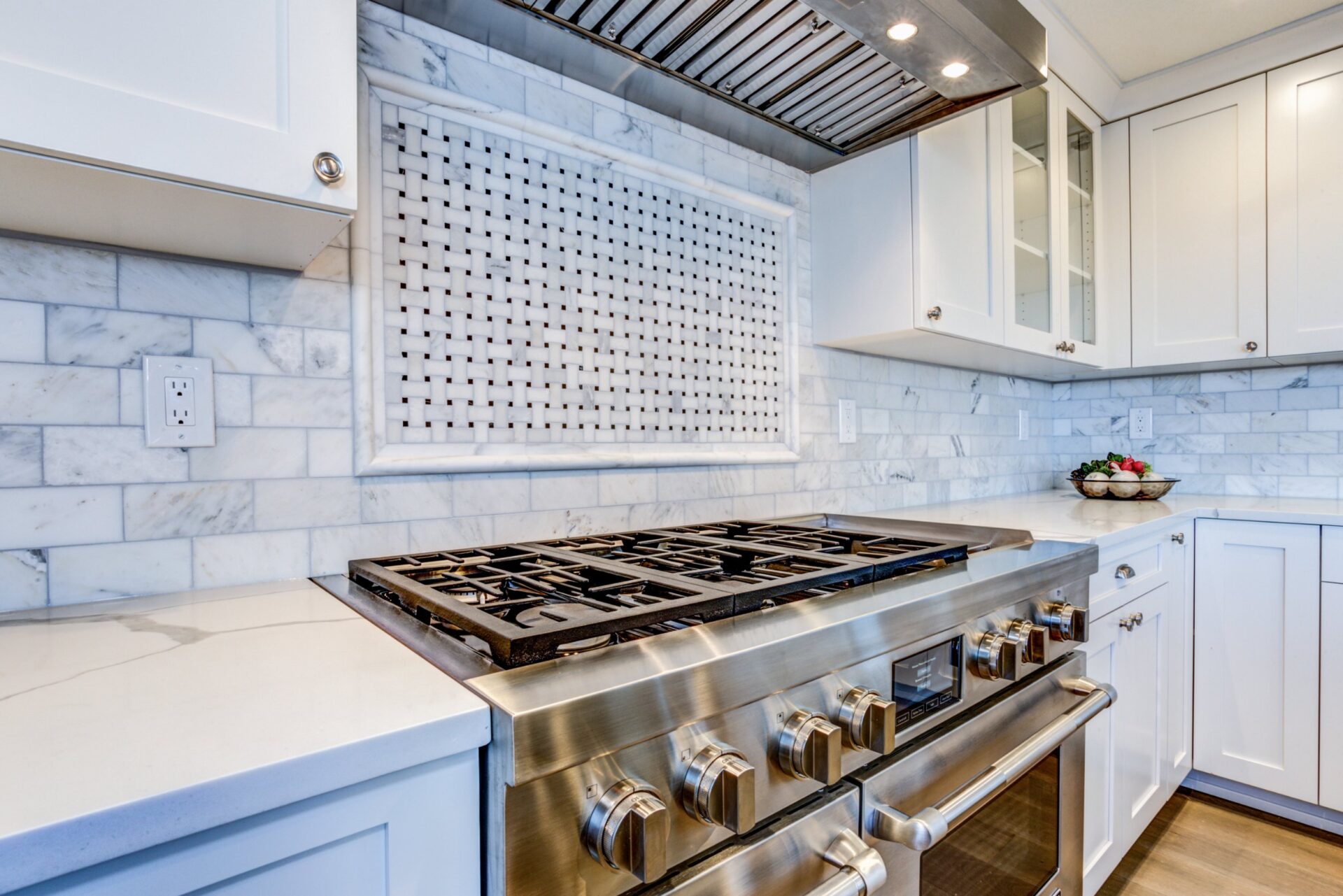 white kitchen with stainless steel hood 